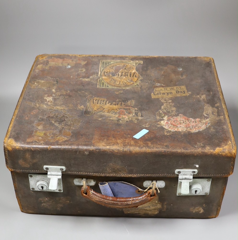 A late Victorian leather travelling vanity case containing five repousse silver topped glass toilet jars, 43.8cm.